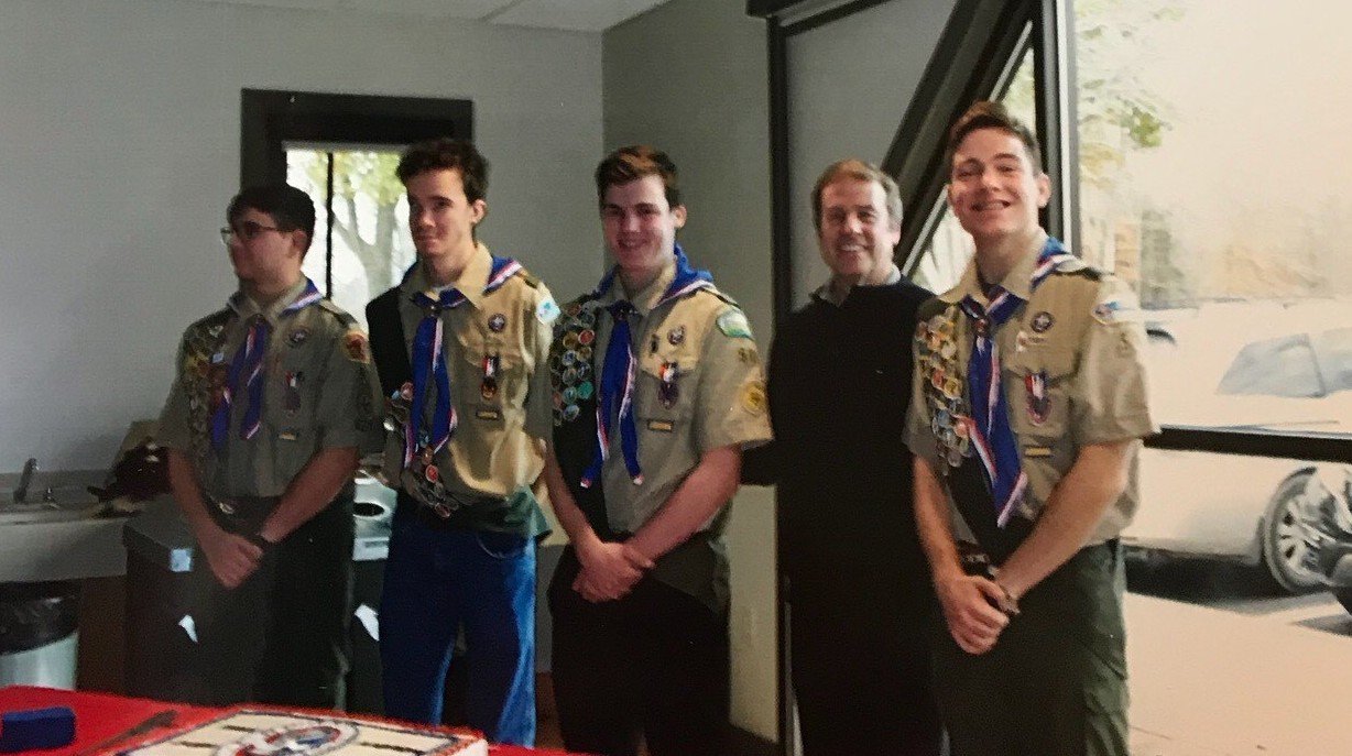 people smiling and some wearing scout uniform